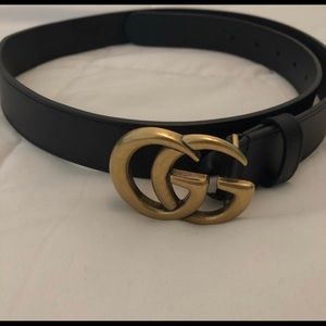 Gold and black Gucci belt
